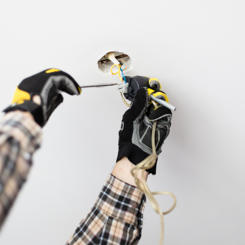 An electrician installing a light